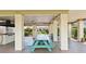 Community outdoor grill area with a large grill and picnic tables, surrounded by green plants at 5971 Terrace Park N Dr # 310, St Petersburg, FL 33709
