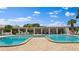 Community pool featuring chairs, lush landscaping and clear, inviting water at 5971 Terrace Park N Dr # 310, St Petersburg, FL 33709