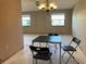 Dining area featuring a contemporary chandelier and an adjacent living space at 5971 Terrace Park N Dr # 310, St Petersburg, FL 33709