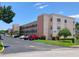 Attractive condo building featuring balconies, assigned parking, and lush landscaping at 5971 Terrace Park N Dr # 310, St Petersburg, FL 33709