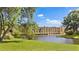 Exterior view of a condo building on a pond with well-maintained grounds and landscaping at 5971 Terrace Park N Dr # 310, St Petersburg, FL 33709