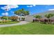 Exterior of a building with a lawn, mature landscaping and an American flag at 5971 Terrace Park N Dr # 310, St Petersburg, FL 33709