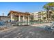 Community pool with covered pavilion, lounge chairs, and nearby buildings, providing a comfortable recreational space at 5971 Terrace Park N Dr # 310, St Petersburg, FL 33709
