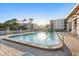 Community pool area with brick patio and various seating options, creating a relaxing atmosphere for residents at 5971 Terrace Park N Dr # 310, St Petersburg, FL 33709