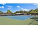 Tennis courts in a community setting with seating and green surroundings at 5971 Terrace Park N Dr # 310, St Petersburg, FL 33709