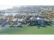 Aerial view of waterfront homes with boats docked along canals and stunning blue waters at 750 123Rd Ave, Treasure Island, FL 33706