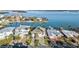 An aerial view showing waterfront homes with lush tropical landscaping and stunning blue waters at 750 123Rd Ave, Treasure Island, FL 33706