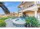 Luxury backyard with a beautiful water feature, outdoor kitchen, and covered patio, creating an ideal entertaining space at 750 123Rd Ave, Treasure Island, FL 33706