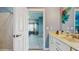 Bathroom featuring a vanity with ample counter space, adjacent to a rec room, offering convenience and functionality at 750 123Rd Ave, Treasure Island, FL 33706