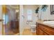 A bathroom features a tiled shower, tropical mural, vanity with granite countertop, and tiled floors at 750 123Rd Ave, Treasure Island, FL 33706