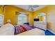 Bedroom featuring yellow walls, white furniture and a bay window with white shutters at 750 123Rd Ave, Treasure Island, FL 33706