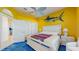 Bright bedroom featuring a nautical decorative fish on the yellow wall at 750 123Rd Ave, Treasure Island, FL 33706