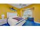 Bright, stylish bedroom featuring a decorative fish, ceiling fan and a large window at 750 123Rd Ave, Treasure Island, FL 33706