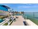 Dock featuring a boat, bench, and a cleaning station with running water at 750 123Rd Ave, Treasure Island, FL 33706