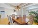 Formal dining room with large wood table, decorative chandelier, and arched windows at 750 123Rd Ave, Treasure Island, FL 33706