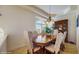 Cozy dining area with a wood table, elegant chandelier, and window at 750 123Rd Ave, Treasure Island, FL 33706