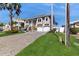 Lovely two-story home boasts a manicured lawn, a paved drive and two-car garage at 750 123Rd Ave, Treasure Island, FL 33706
