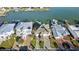 An eye-level aerial shot shows neighborhood homes with manicured lawns and personal boat docks at 750 123Rd Ave, Treasure Island, FL 33706