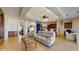 Open-concept living room featuring a skylight, tile floors, recliners, and access to a dining area at 750 123Rd Ave, Treasure Island, FL 33706