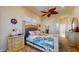 Inviting bedroom with ceiling fan, shuttered windows, and tropical-themed décor at 750 123Rd Ave, Treasure Island, FL 33706