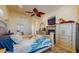 Comfortable bedroom with a ceiling fan, fireplace, and decorative accents at 750 123Rd Ave, Treasure Island, FL 33706