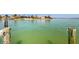 View of the waterfront featuring a dock, boat and luxury homes at 750 123Rd Ave, Treasure Island, FL 33706