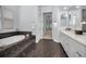 Relaxing bathroom featuring a soaking tub, tiled floor, and dual sink vanity at 7888 Lantana Creek Rd, Largo, FL 33777