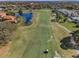 Picturesque aerial view of a lush golf course community featuring lakes, trees, and luxury homes at 7888 Lantana Creek Rd, Seminole, FL 33777