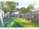 Spacious backyard with green grass, mature trees and a shed at 7990 42Nd N St, Pinellas Park, FL 33781