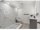 Bright, remodeled bathroom with a tiled walk-in shower, modern toilet and vanity at 7990 42Nd N St, Pinellas Park, FL 33781