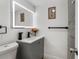 Remodeled bathroom offers a sleek gray vanity with a backlit mirror and modern fixtures at 7990 42Nd N St, Pinellas Park, FL 33781