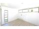 A spacious bedroom features wood-look flooring, natural light from the windows, and playful wall decorations at 7990 42Nd N St, Pinellas Park, FL 33781
