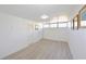 Vacant bedroom with wood-look flooring features natural light from the window and ample closet space at 7990 42Nd N St, Pinellas Park, FL 33781