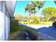 A bright home with a driveway, palm trees, and green grass at 7990 42Nd N St, Pinellas Park, FL 33781