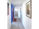A light and bright foyer with decor, gray floors, and a red door at 7990 42Nd N St, Pinellas Park, FL 33781