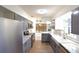 Updated kitchen boasts stainless steel appliances, grey cabinetry and marble countertops at 7990 42Nd N St, Pinellas Park, FL 33781