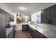 Beautifully updated kitchen with stainless steel appliances, marble countertops, and gray cabinetry at 7990 42Nd N St, Pinellas Park, FL 33781