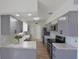 Spacious kitchen featuring modern appliances, marble countertops, and gray cabinets at 7990 42Nd N St, Pinellas Park, FL 33781