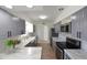 Bright kitchen with stainless appliances, marble counters, farmhouse sink, and gray cabinetry at 7990 42Nd N St, Pinellas Park, FL 33781