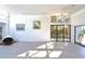 Bright living room with a fireplace, modern lighting, and sliding doors to the pool area at 7990 42Nd N St, Pinellas Park, FL 33781