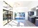 Spacious living area featuring hardwood floors, grey cabinets, and sliding doors leading to pool at 7990 42Nd N St, Pinellas Park, FL 33781