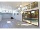 Bright living room featuring a fireplace, modern lighting, and sliding glass doors leading to a pool at 7990 42Nd N St, Pinellas Park, FL 33781