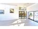 Open living area featuring hardwood floors and abundant natural light from large windows at 7990 42Nd N St, Pinellas Park, FL 33781