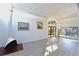 Open-concept living room with fireplace, unique lighting, and sliding glass doors to the backyard at 7990 42Nd N St, Pinellas Park, FL 33781