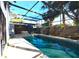 Enclosed pool area features a hot tub, a pool with stepping stones and mature trees around the perimeter at 7990 42Nd N St, Pinellas Park, FL 33781