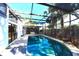Enclosed pool area features a hot tub, a pool with stepping stones and mature trees around the perimeter at 7990 42Nd N St, Pinellas Park, FL 33781