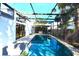 Enclosed pool area features a hot tub, a pool with stepping stones and mature trees around the perimeter at 7990 42Nd N St, Pinellas Park, FL 33781