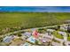 Aerial view showcasing a property with a pool near lush greenery and a waterfront at 8517 43Rd W Ave, Bradenton, FL 34209