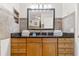 Bathroom with granite countertops, wooden cabinets, and modern light fixture at 8517 43Rd W Ave, Bradenton, FL 34209