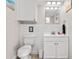 Clean and modern half-bathroom with tile backsplash, white vanity and toilet at 8517 43Rd W Ave, Bradenton, FL 34209